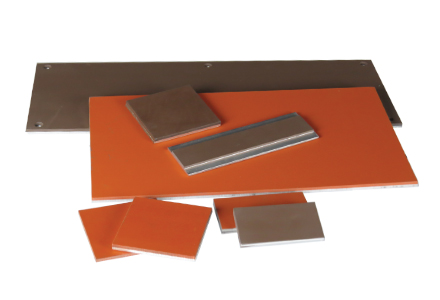 A color photo of a sample selection of both unbonded and silicone-to-metal bonded high temperature silicone rubber sheets.