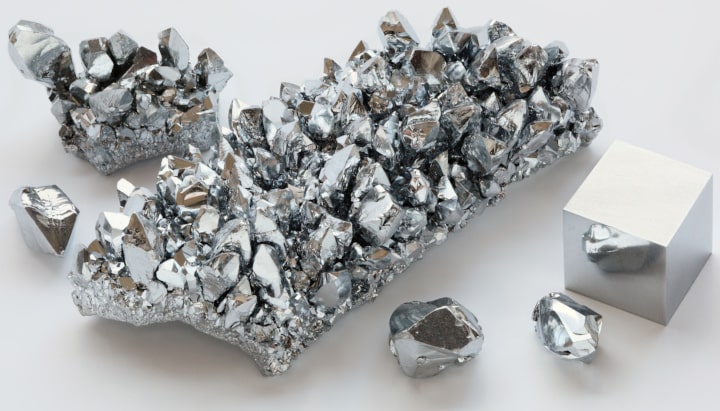 Chromium crystals and a cubic centimeter cube of refined chromium.