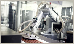 A color photo of a pick and place automated food handling robot.