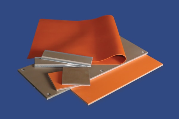 A color photo of both unbonded and silicone-to-metal bonded high temperature silicone rubber sheets.