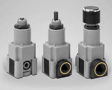 Three plastic pressure regulators with various connections and control knobs.